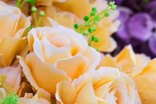 Yellow fabric roses,Fake textile yellow roses close-up floral background