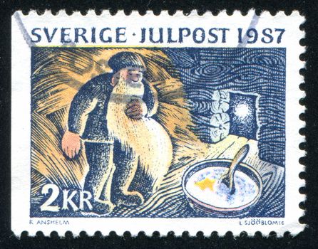 SWEDEN - CIRCA 1987: stamp printed by Sweden, shows Putting porridge in the stable for the gray Christmas elf, circa 1987