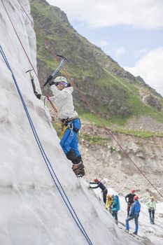Girl climb up on the ice at glacier