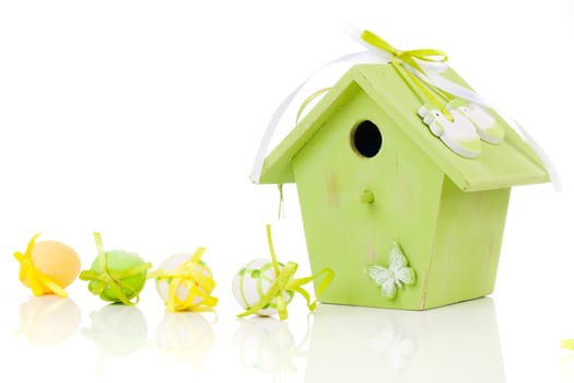 Easter eggs with birdhouse, on a white background