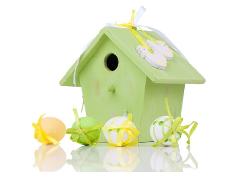 Easter eggs with birdhouse, on a white background