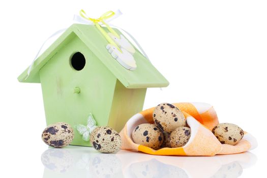quail eggs with birdhouse, on a white background
