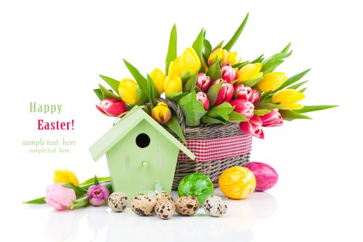 Easter eggs with tulips flowers and birdhouse, on a white background