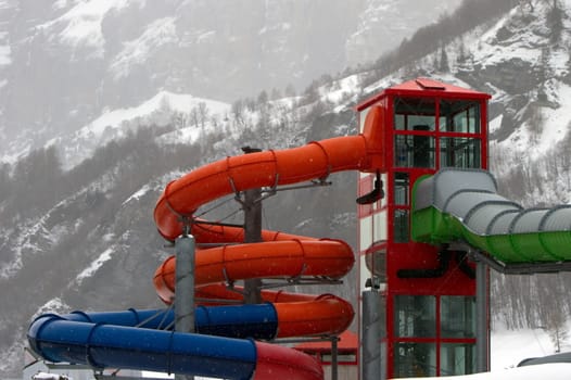 Colorful water park close by winter day in the mountain