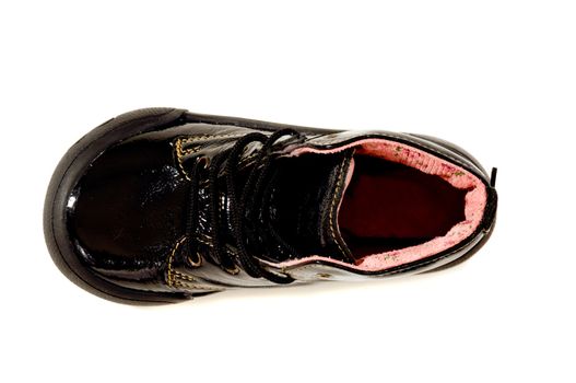 A black childs shoe. Isolated on a clean white background.