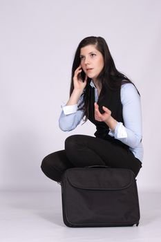 Young woman is squatting with a bag for your laptop and phone