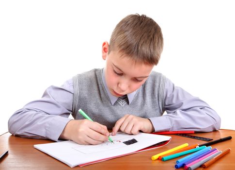 Cute Kid Drawing at the School Desk Isolated on the White Background