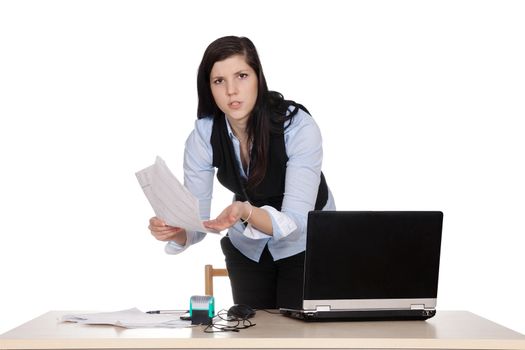 Young female boss at table with laptop holding papers in hand, and upsets, isolated on white background