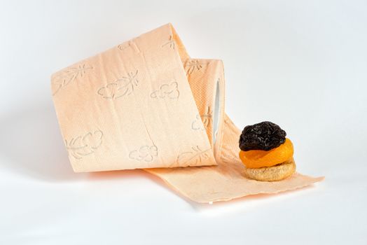 Prunes, dried apricots, fig and roll of pink toilet paper