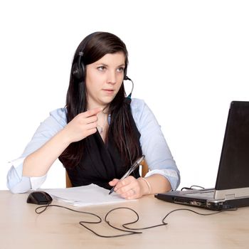 Phone young woman with headsets and writes with a pen on paper and shows with finger and sits at the table with laptop, isolated on white background