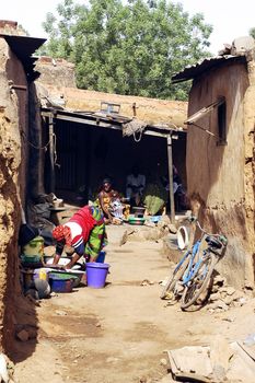 an old lane Bobo-Dioulasso where women are busy with household activities