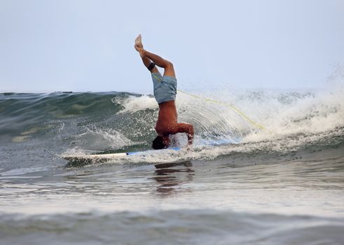 Young men - the surfer in ocean. Bali. Indonesia