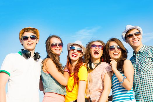 group of young people wearing sunglasses and hats hugging and standing in a row, spending time with friends