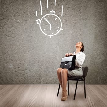 image of a young business woman looking at the sketched clock