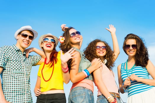 group of young people wearing sunglasses and hats hugging and standing in a row, spending time with friends