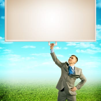 image of a businessman holding a banner with one hand, place for text