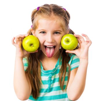 little girl with two apples shows tongue isolated on white background