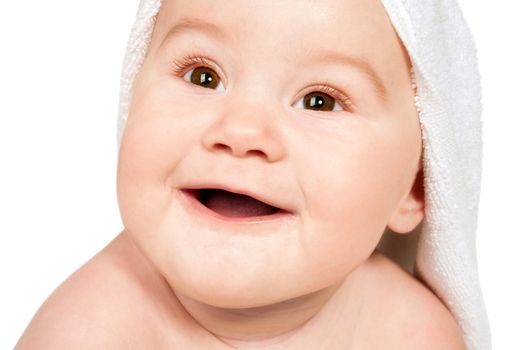 Smiling child with a towel on his head. Isolated on white