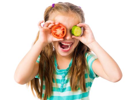 little girl with cucumber and tomato slices around the eyes isolated on white background