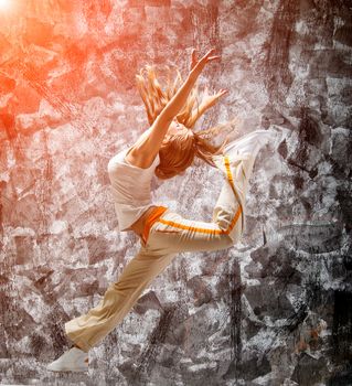 jumping girl on a gray grunge background