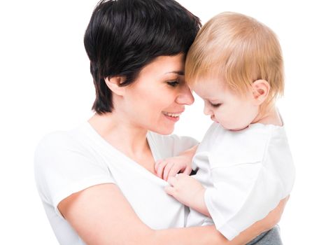 Brunette holding a baby in her arms. Isolated on white