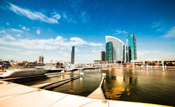 City quay with yachts and tall buildings