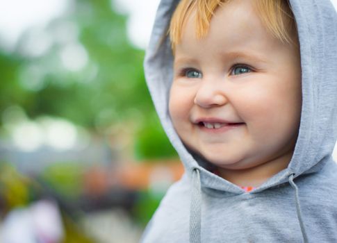 cute smiling face of a young child in the park