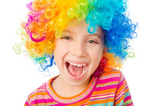 smiling little girl in clown wig isolated on white background