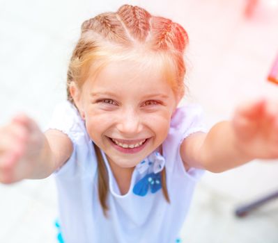 cute little girl smiling in a park close-up