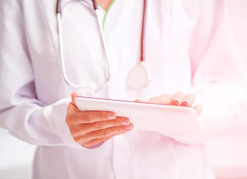 Doctor using a white digital tablet