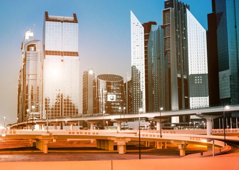 evening landscape of a modern city with bridges, roads and skyscrapers