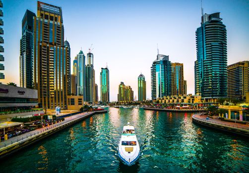 DUBAI, UAE - DECEMBER 14: Modern buildings in Dubai Marina, on december 14, 2013, Dubai, UAE. In the city of artificial channel length of 3 kilometers along the Persian Gulf.