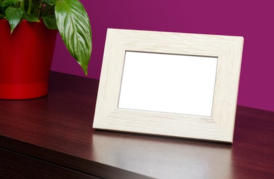 Blank wooden photo frame on the dresser