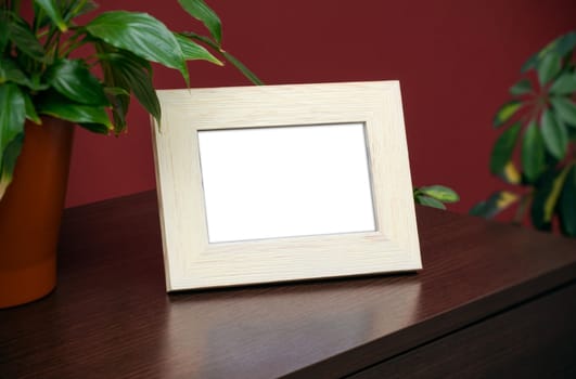 Blank wooden photo frame on the dresser