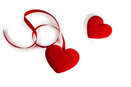 Two Red  Hearts  with red ribbon isolated on white (with path)
