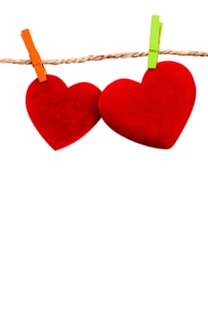 Cute big red heart hanging on the clothesline. On white  background