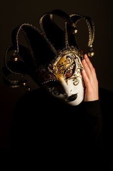 a portrait with Jester mask on black background