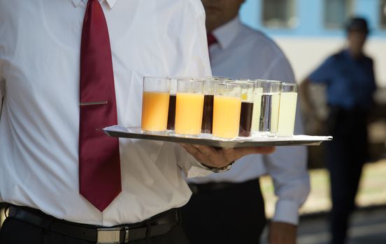 Waiter serving soft drinks at a party