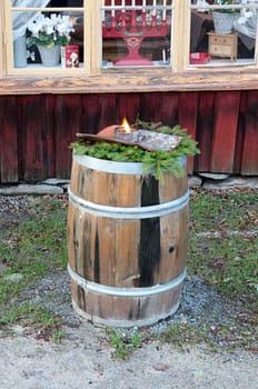 an old wooden barrel with burning torches at Christmas