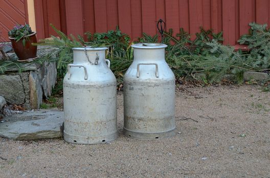 Old milk jug of metall on a farm