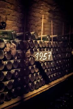 some very old and dusty wine bottles in a wine cellar