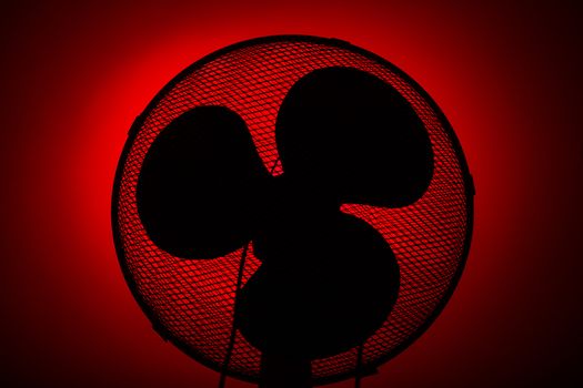 black fan silhouette on red background with vignete