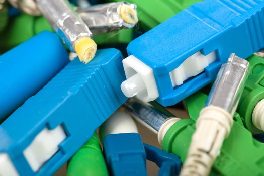 closeup of various types of fiber optic connectors, in front SC type