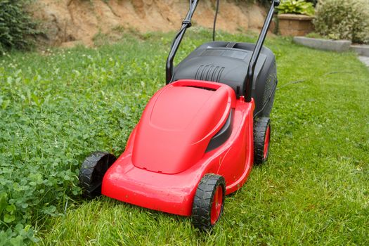  new lawnmower on green grass in cloudy day