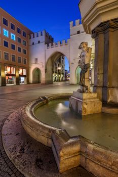 Brunnenbuberl Fountain and Karlstor Gate in the Evening, Munich, Germany