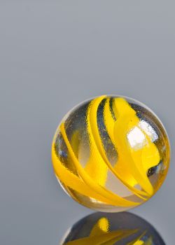 single yellow glass marble isolated 