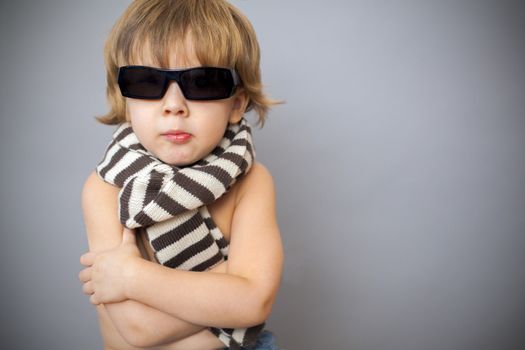 boy in sunglasses and striped scarf
