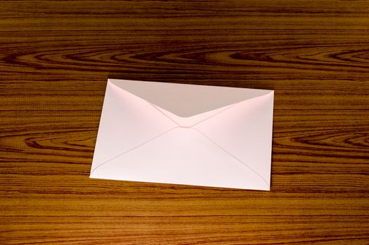 soft pink envelope on wooden background