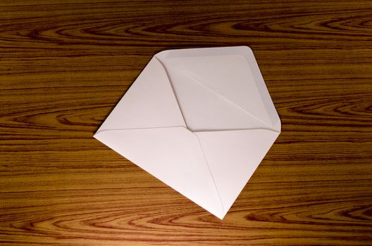 soft pink envelope on wooden background