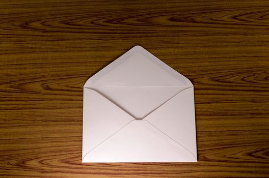 soft pink envelope on wooden background